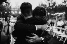 professional best man speech writer A picture of two brothers hugging.