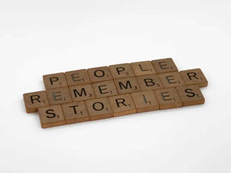 Wooden blocks spelling out: "People remember stories"